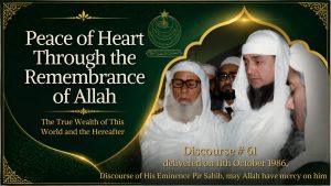An elderly Muslim scholar in white robes and turban stands among several men in an airport terminal.
